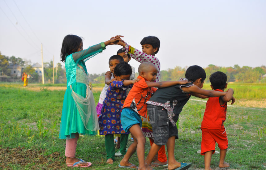 A group of six kids playing outdoors.