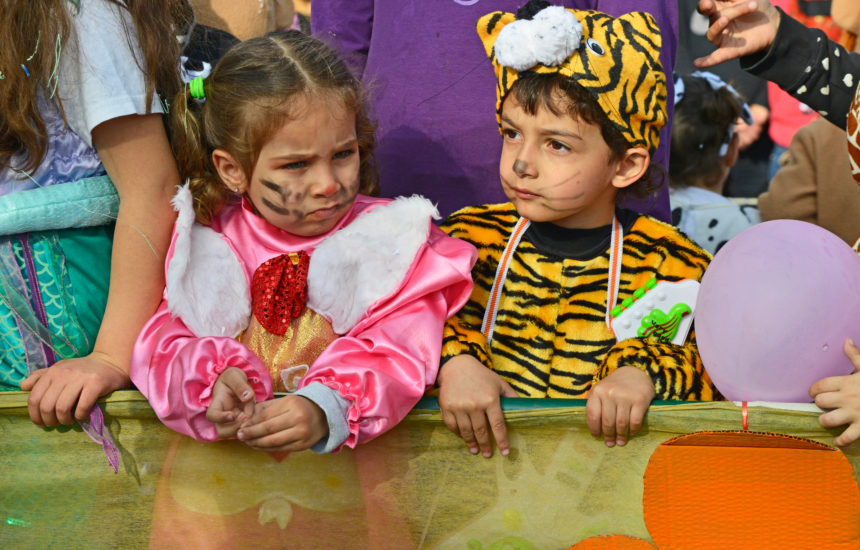 2 young kids dressed in animal costumes.