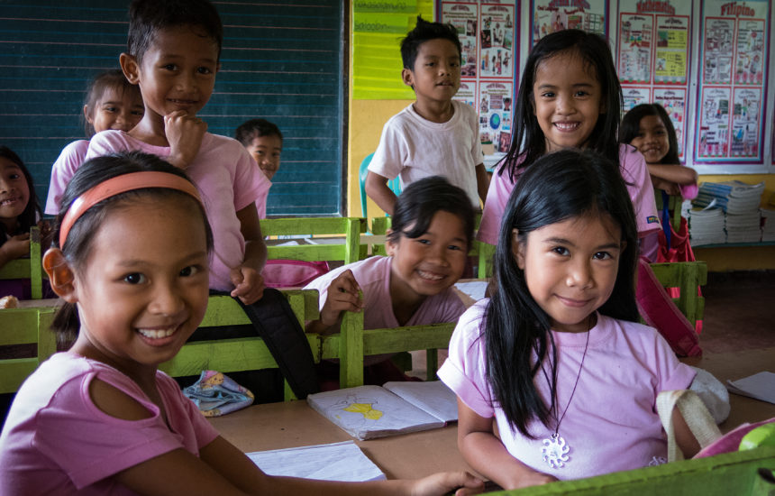 A classroom of children smiling.