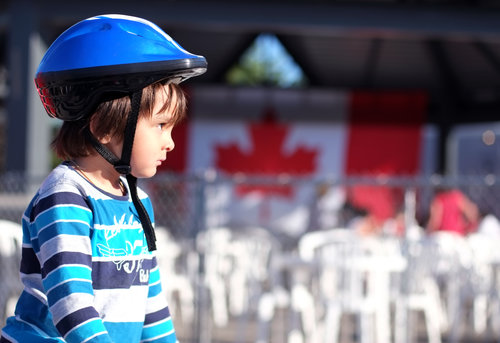 A young boy wearing a bicycle helmet.