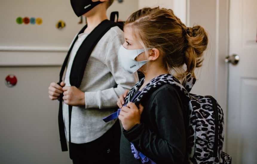 Kids wearing face masks and backpacks