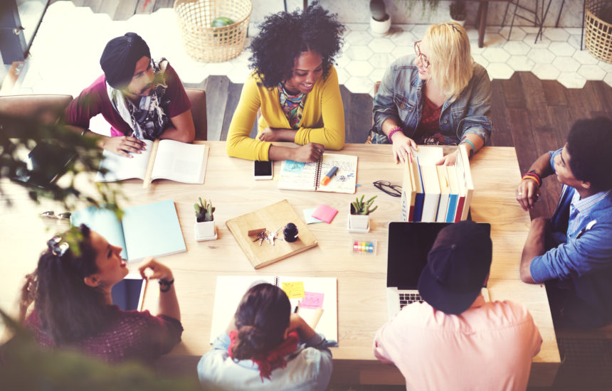 Diverse group engaged in cocreation and professional learning.