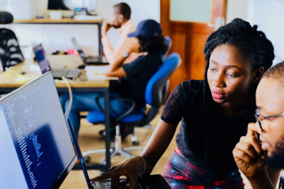 Colleagues working on computers together