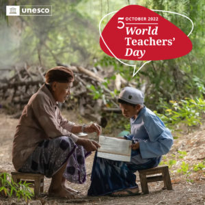 5 October World Teachers Day. Photo of man and boy outdoors, looking at a book