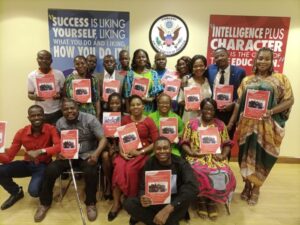 A group of educators posing with the final report from the inclusive education training