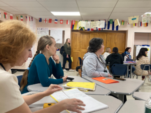People sitting at desks, listening to presentation