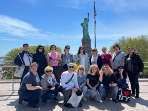 Group of people behind the Statue of Liberty