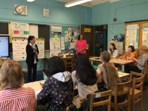 A group of people meeting in a classroom
