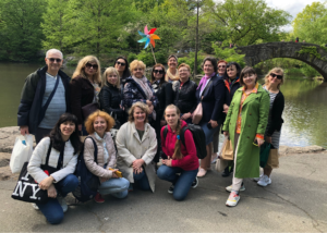 Group of Ukrainian educators standing by the water and a bridge in New York City