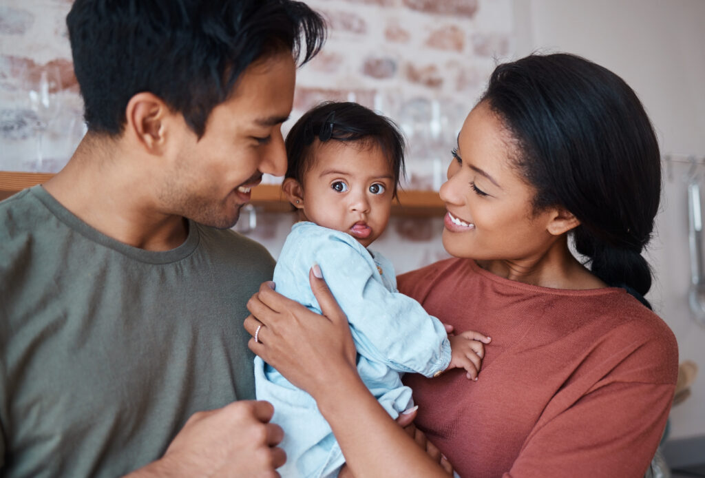 Happy mom and dad holding a baby