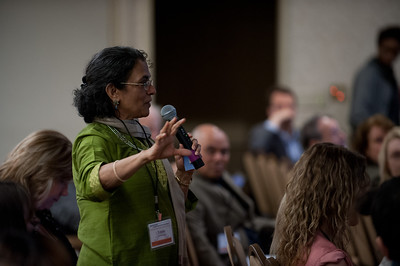 A teacher asking a question at a conference.