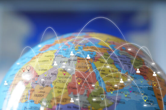 A globe with connection points between places rising above it.