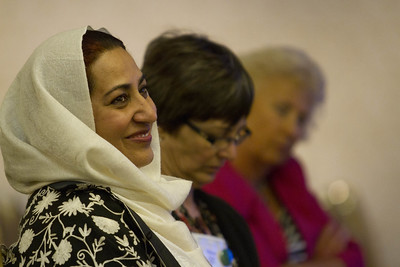 Teachers smiling while attending a conference session.