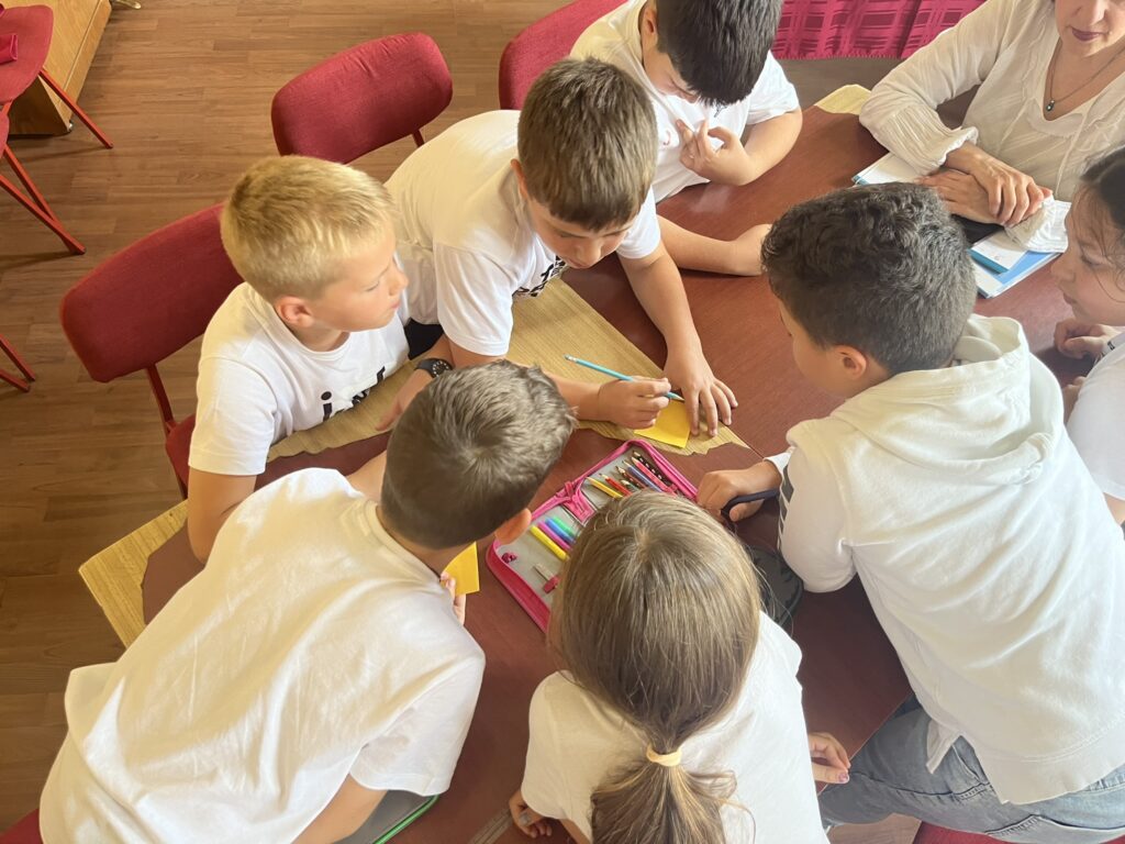 A group of kids working on a project together at a table