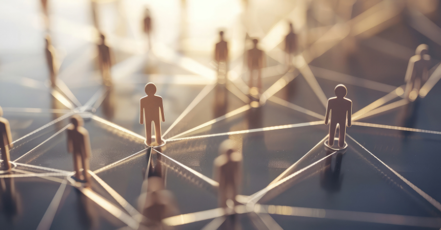 An image of people figurines standing with network connections between them to represent child development and business partnerships.