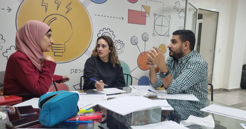 Three teachers in a professional development workshop.