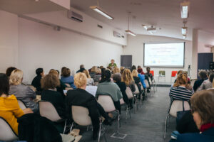 Conference attendees watching a presentation.