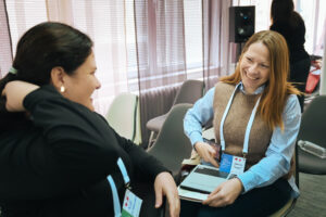 CE International's Katherine Tek speaking with a conference participant.