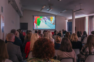 Conference attendees watching a presentation about social-emotional learning.
