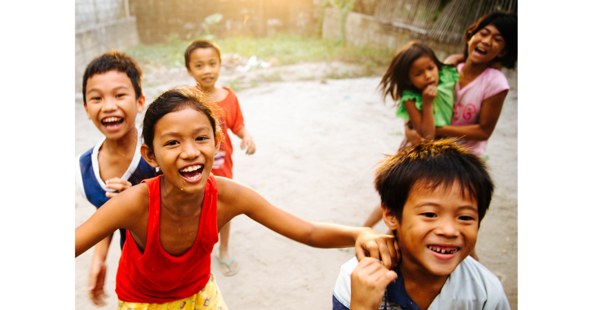 Happy children, laughing while they play outdoors.