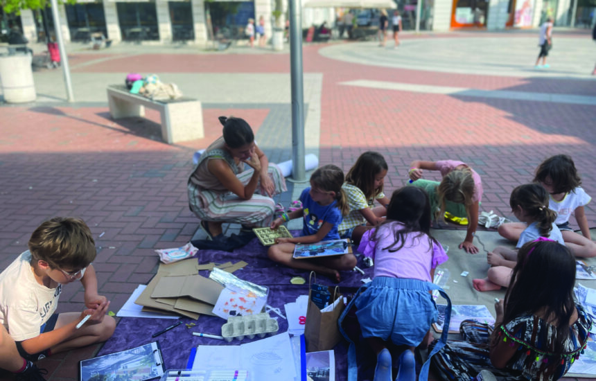 Children playing outdoors and doing art.